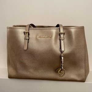 Gently used gold Michael Kors purse.